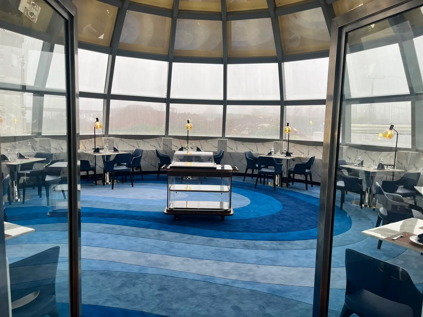 Looking through the glass doors into the domed dining room of The Eye