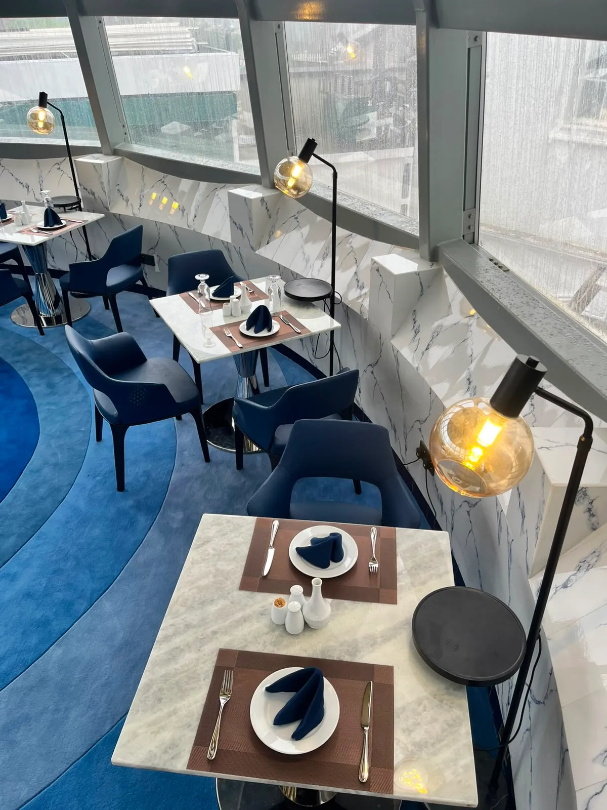 The dessert trolley at the heart of The Eye, encircled by rings of blue carpet