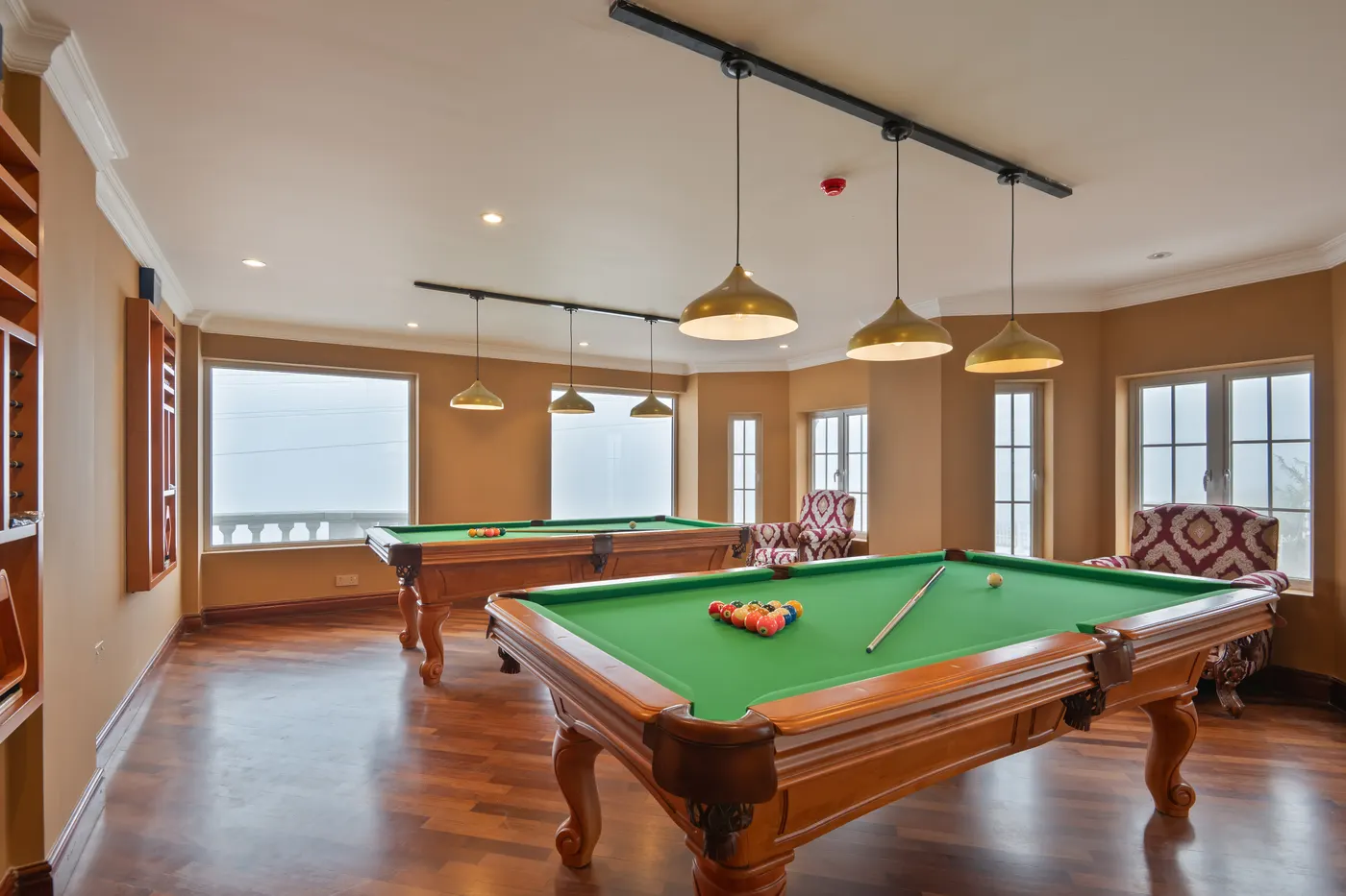 Billiards room with a full-size pool table and lake windows