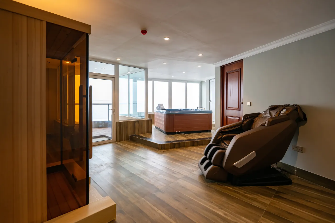 Spa lounge with a cedar sauna and massage chair