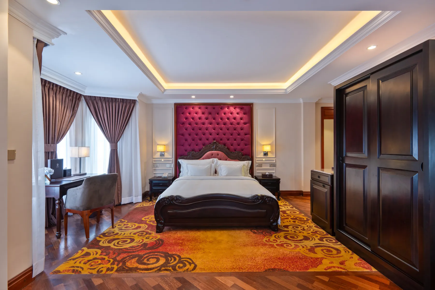 The Family Suite at Horton Heights, its carved bed set on a swirling gold carpet