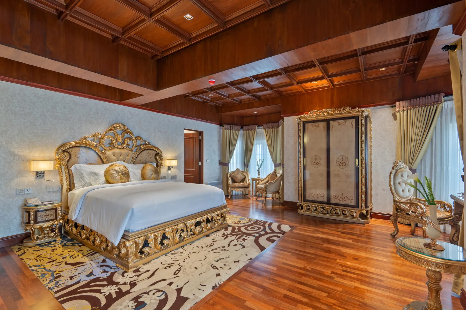The gilded Royal Suite at Horton Heights beneath a coffered mahogany ceiling